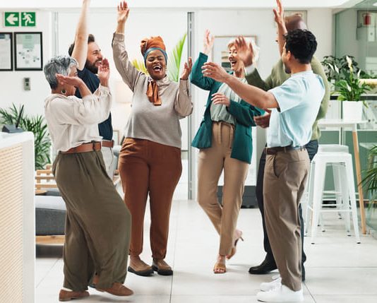 Why Great Teams Need Both the Positive Emotions of Sustaining and Striving Employees in the office showing positive emotions