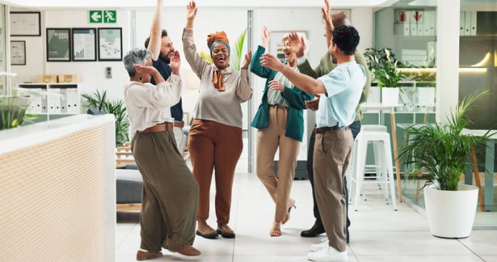 iStock-2186384071 (1) Employees in the office showing positive emotions
