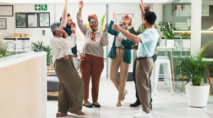 Why Great Teams Need Both the Positive Emotions of Sustaining and Striving Employees in the office showing positive emotions