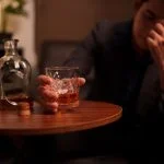 Alcohol - Businessman holding a glass of whiskey