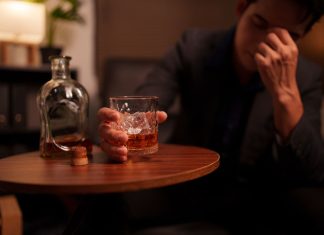 Alcohol - Businessman holding a glass of whiskey