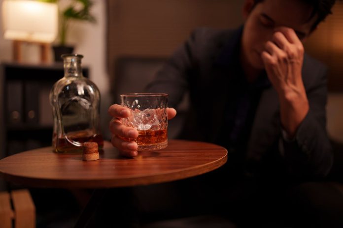 Alcohol - Businessman holding a glass of whiskey