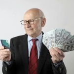 Man holding credit card and cash from loan