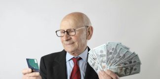 Essential Guide to 401k Loans: Uses, Credit Impact and Key Facts Man holding credit card and cash from loan