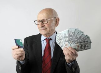 Man holding credit card and cash from loan