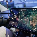 Car dashboard with navigation map on touchscreen.