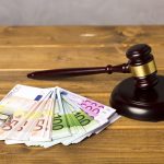 What to Consider Before Applying for a Lawsuit Loan gavel with euro bank notes for Lawsuit Loan