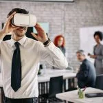 Businessman wearing VR glasses and having fun at work.
