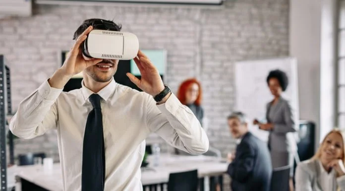 Training the Workforce of Tomorrow with VR Simulations Businessman wearing VR glasses and having fun at work.