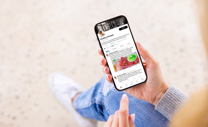 Woman viewing wellness lifestyle advice on creator's profile page on social media app