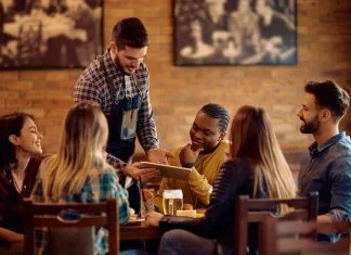 10 Seasonal Promotions Ideas to Attract More Diners Waiter doing Promotions to attract customer in restaurant