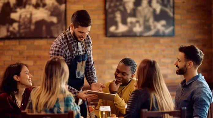 10 Seasonal Promotions Ideas to Attract More Diners Waiter doing Promotions to attract customer in restaurant