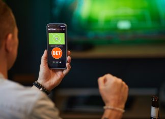 Person engaged in online soccer sports betting technoloy
