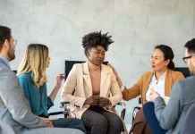 Support with group, therapy and mental health with help, people together talking about problem