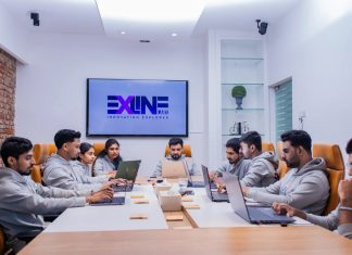 What is Outsourced Application Development and Why Do Companies Use It? Person Outsourced Application software development working on coding computer screen and flowchart at night in modern office