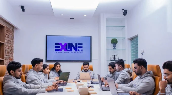 What is Outsourced Application Development and Why Do Companies Use It? Person Outsourced Application software development working on coding computer screen and flowchart at night in modern office