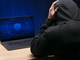 Close up programmer at desk with laptop experiencing False Scam Narratives in Offshore Finance