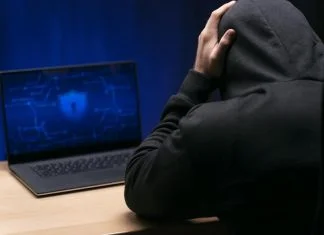 Dissecting False Scam Narratives in Offshore Finance: Why Transparent Knowledge Platforms Face Manufactured Attacks Close up programmer at desk with laptop experiencing False Scam Narratives in Offshore Finance