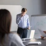 Overcoming Stage Fright at Work: Mind Hacks That Really Work nervous employee wipe face scared to speak in public. Person with stage fright