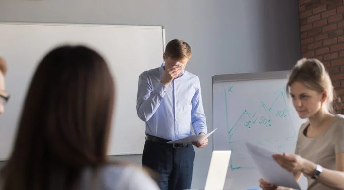 Overcoming Stage Fright at Work: Mind Hacks That Really Work nervous employee wipe face scared to speak in public. Person with stage fright
