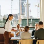 Beyond Virtue: How Effective Leaders Work With, and Change Values Business team applauding leader with values for successful strategy planning