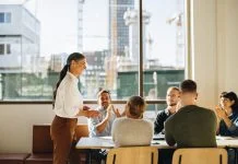 Business team applauding leader with values for successful strategy planning