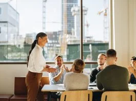 Business team applauding leader with values for successful strategy planning