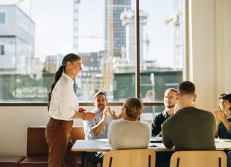 Business team applauding leader with values for successful strategy planning