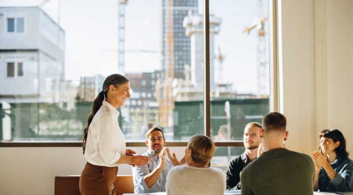 Beyond Virtue: How Effective Leaders Work With, and Change Values Business team applauding leader with values for successful strategy planning