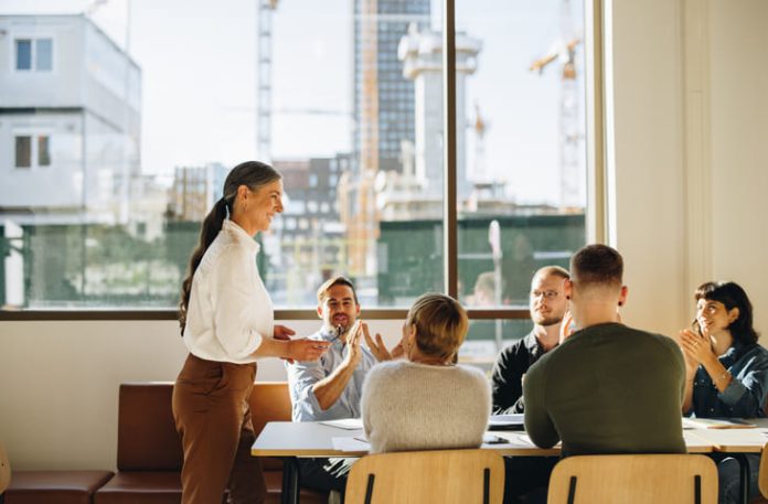 iStock-1318282275 (1) Business team applauding leader with values for successful strategy planning