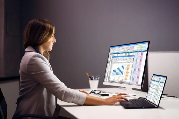 Woman Using Finance Spreadsheet Report Top 9 Accounts Receivable (AR) Software Solutions for 2026