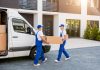 Workers unloading boxes for relocation