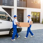 Workers unloading boxes for relocation