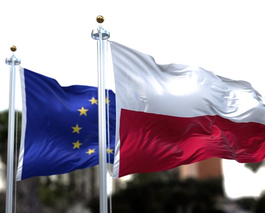 European Strategic Autonomy: Is Poland Going Far Enough? The flags of Poland and the European Union waving in the wind.