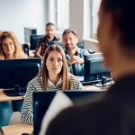College student listening to the professor during lecture about AI