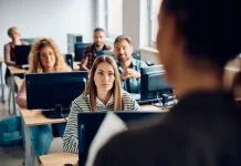 College student listening to the professor during lecture about AI
