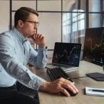 Forex trading broker analyzing market, looking at screen of PC