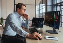 Forex trading broker analyzing market, looking at screen of PC