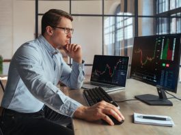 Forex Trading for Beginners: Your Complete Guide to Financial Freedom Forex trading broker analyzing market, looking at screen of PC