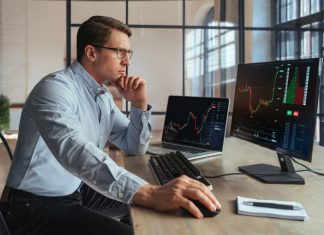 Forex trading broker analyzing market, looking at screen of PC