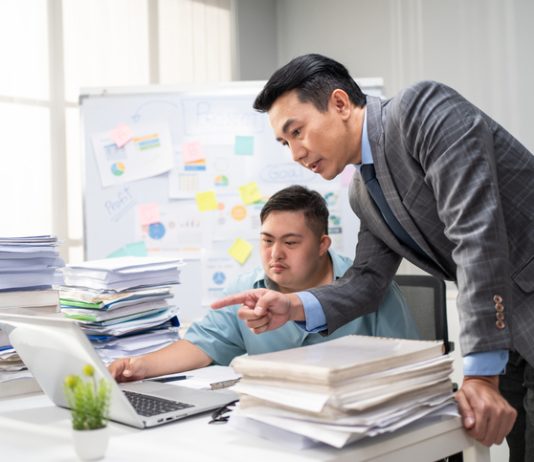 Employee man with autism or AuDHD at Work brainstorm plan and discuss project with manager leader. Corporate of modern colleague