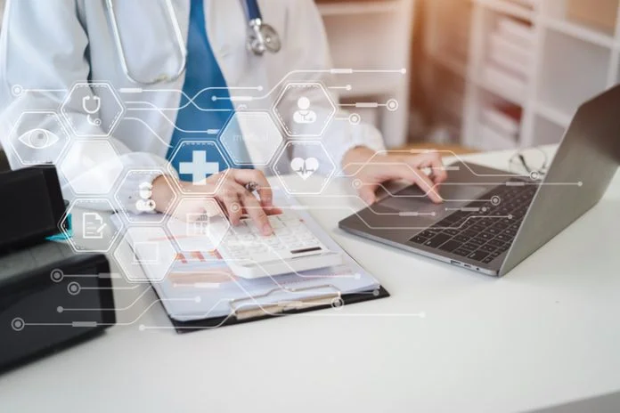 Doctor working in hospital use calculator, Healthcare and medical concept. Healthcare Accounts Receivable