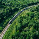How 5G-FRMCS Can Accelerate EU’s Rail Transformation 5G train in beautiful green summer forest. Long commuter train moving to rail way station