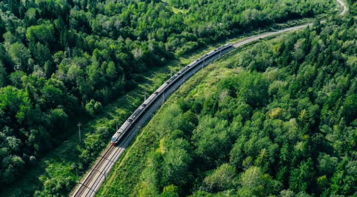 How 5G-FRMCS Can Accelerate EU’s Rail Transformation 5G train in beautiful green summer forest. Long commuter train moving to rail way station