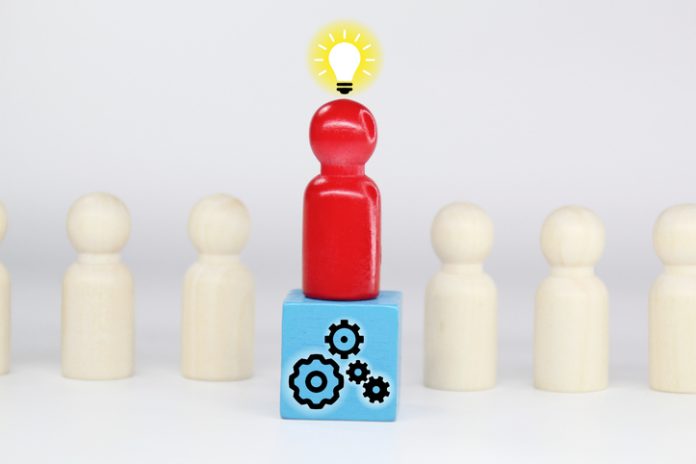 peg dolls, colored cubes with Idea and teamwork icons Business leader with wisdom