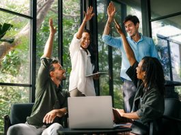 How to Set Teams Up for Success Diverse team celebrating their success and the great work environment