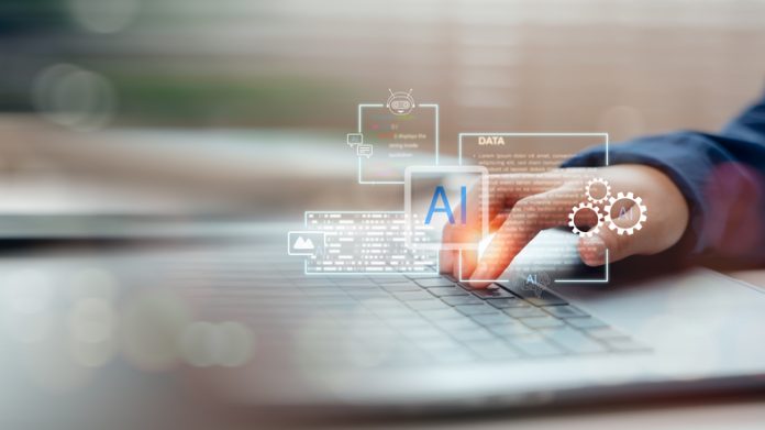 Hand interacting with virtual AI assistant on laptop keyboard. Concept of artificial intelligence in data analysis, automation, machine learning, and digital transformation. Data for Effective AI Deployment