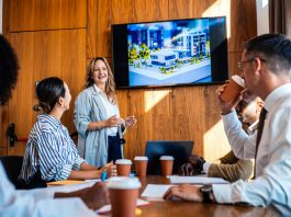 The 20:70:10 Rule for a Blockbuster Presentation employees in the workplace watching blockbuster video as presentation during a meeting