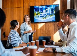 The 20:70:10 Rule for a Blockbuster Presentation employees in the workplace watching blockbuster video as presentation during a meeting