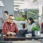 Why 996, 5-Day, and 4-Day Workweeks Impact Freelancers and Full-Timers Differently Freelancers working using computer